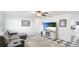 Bright living room with a ceiling fan, checkered floors, and comfortable gray seating at 2312 Java Plum Ave, Sarasota, FL 34232