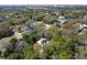 Aerial view of property surrounded by lush trees and featuring a bright red umbrella at 2613 Temple St, Sarasota, FL 34239
