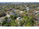 Aerial view of property surrounded by lush trees and featuring a bright red umbrella at 2613 Temple St, Sarasota, FL 34239