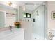 Bright bathroom featuring a walk-in shower with patterned tile and glass door at 2613 Temple St, Sarasota, FL 34239