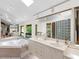 Bathroom featuring a large tub, double vanity, and a skylight at 2613 Temple St, Sarasota, FL 34239