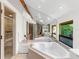 Bathroom featuring a large soaking tub and a walk-in shower at 2613 Temple St, Sarasota, FL 34239