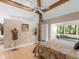 Bedroom with a textured wall, large window and a comfortable chaise lounge at 2613 Temple St, Sarasota, FL 34239