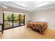 Bright bedroom with a sliding glass doors that opens to a balcony with lush views at 2613 Temple St, Sarasota, FL 34239