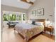 Bedroom featuring a large window view, ceiling beam and comfortable furniture at 2613 Temple St, Sarasota, FL 34239