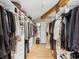 Walk-in closet boasting custom built-ins, hardwood floors, and a skylight for an elevated storage experience at 2613 Temple St, Sarasota, FL 34239