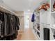 Walk-in closet with custom shelving and hanging racks for optimal organization at 2613 Temple St, Sarasota, FL 34239