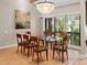 Bright dining room features a glass table and a stylish chandelier over the dining area at 2613 Temple St, Sarasota, FL 34239