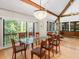 Elegant dining room featuring a modern chandelier, glass table, and natural light from large windows at 2613 Temple St, Sarasota, FL 34239