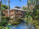 Secluded two-story home surrounded by lush tropical foliage and tranquil waters at 2613 Temple St, Sarasota, FL 34239