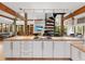 Open kitchen with modern white cabinets, an island cooktop, and views into the living areas at 2613 Temple St, Sarasota, FL 34239