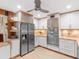Well-lit kitchen boasts stainless steel appliances, ample storage, and light wood flooring at 2613 Temple St, Sarasota, FL 34239