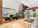 Spacious kitchen featuring a central island with a stovetop, seating, and a view of the living room at 2613 Temple St, Sarasota, FL 34239