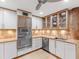 Functional kitchen with built-in stainless steel appliances, bright lighting, and decorative backsplash at 2613 Temple St, Sarasota, FL 34239