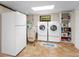Laundry room features modern washer and dryer units, refrigerator, and ample storage solutions at 2613 Temple St, Sarasota, FL 34239