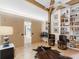 Open and airy living room with a bar cart, and a view to the next room at 2613 Temple St, Sarasota, FL 34239