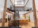 Open-concept living room with a spiral staircase and high ceilings at 2613 Temple St, Sarasota, FL 34239