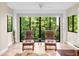 Bright living room with comfortable seating and a wall of windows overlooking lush greenery at 2613 Temple St, Sarasota, FL 34239