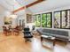 Open concept living room with vaulted ceilings, wood beams, and abundant natural light at 2613 Temple St, Sarasota, FL 34239