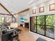 Large living room with vaulted ceilings, a fireplace, and access to a private balcony at 2613 Temple St, Sarasota, FL 34239