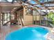 Inviting indoor pool area with wooden deck, glass ceiling, and modern architecture at 2613 Temple St, Sarasota, FL 34239