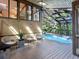 Relaxing sunroom with a partially glass ceiling and an inviting blue pool at 2613 Temple St, Sarasota, FL 34239
