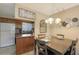 Dining area with a wood table and access to a kitchen area in an open floor plan layout at 2620 Hidden Lake N Dr # B, Sarasota, FL 34237