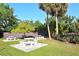 Community picnic area featuring stone picnic tables and well-maintained grassy landscaping under a bright blue sky at 2620 Hidden Lake N Dr # B, Sarasota, FL 34237