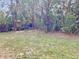 Spacious backyard with grass, mature trees, and a fence at 2712 36Th Avenue E Ter, Bradenton, FL 34208