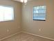 Neutral bedroom with carpet, two windows, and baseboard trim at 2712 36Th Avenue E Ter, Bradenton, FL 34208