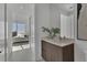 Stylish bathroom with a modern vanity and a view through to the bedroom with waterfront scenery at 301 Quay Commons # 1811, Sarasota, FL 34236