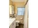 Bright bathroom features a white vanity with sleek hardware and a modern sink and faucet at 3308 W Dewey St, Tampa, FL 33607