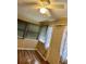Inviting living room featuring wood floors, neutral walls, a ceiling fan, and abundant natural light at 3308 W Dewey St, Tampa, FL 33607