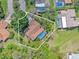 Aerial view of the property showcasing its private pool, mature trees, and well-defined property lines at 3970 Country View Dr, Sarasota, FL 34233