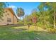 Expansive backyard featuring mature landscaping and a well-maintained lawn at 3970 Country View Dr, Sarasota, FL 34233