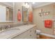 Bathroom featuring double sinks, granite countertop, and decorative coastal accents at 3970 Country View Dr, Sarasota, FL 34233