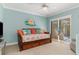 Comfortable bedroom featuring a daybed, sliding glass doors, and charming coastal decor at 3970 Country View Dr, Sarasota, FL 34233