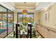 Bright dining room with access to the pool and decorated with tropical accents at 3970 Country View Dr, Sarasota, FL 34233