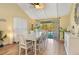 Elegant dining area with a view of the pool, complemented by stylish furnishings and ample natural light at 3970 Country View Dr, Sarasota, FL 34233