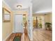 Bright foyer with wood flooring, decorative mirror, and view of a private courtyard with a water feature at 3970 Country View Dr, Sarasota, FL 34233