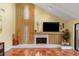 Warm living room features a floor-to-ceiling fireplace, tile floors, and ample space for entertaining at 3970 Country View Dr, Sarasota, FL 34233