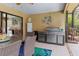 Outdoor patio features a stainless steel grill, dining area, and view of the backyard at 3970 Country View Dr, Sarasota, FL 34233