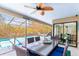 Covered patio with a dining table, ceiling fan, and a view of the pool area at 3970 Country View Dr, Sarasota, FL 34233