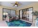 Cozy covered patio with seating, a ceiling fan, and views of the surrounding area at 3970 Country View Dr, Sarasota, FL 34233