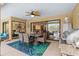 Covered patio with a dining table, grill, and access to indoor living spaces at 3970 Country View Dr, Sarasota, FL 34233