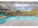 Sparkling screened pool surrounded by ample patio space, perfect for outdoor entertaining at 3970 Country View Dr, Sarasota, FL 34233