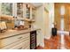 Wet bar featuring granite countertops, glass cabinetry, and a built-in wine cooler at 3970 Country View Dr, Sarasota, FL 34233