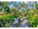 Lush backyard with outdoor table and chairs, creating an inviting retreat at 4062 S Shade Ave, Sarasota, FL 34231