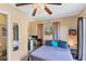 Studio bedroom with ceiling fan, small refrigerator, and a window at 4062 S Shade Ave, Sarasota, FL 34231