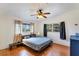 A well-lit bedroom features hardwood floors, a ceiling fan, and large windows at 4062 S Shade Ave, Sarasota, FL 34231